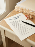The 17-Document Checklist printable on a desk with a pen, dried flowers and manila folders